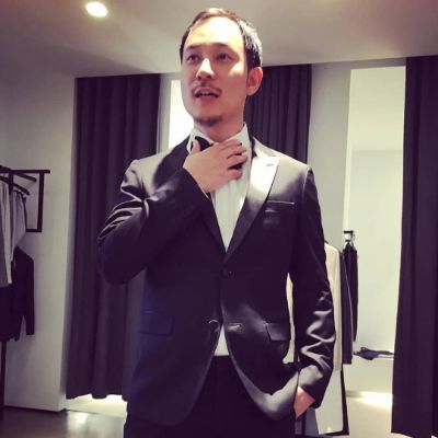 American executive and businessman, Justin Hakuta, wearing a suit.